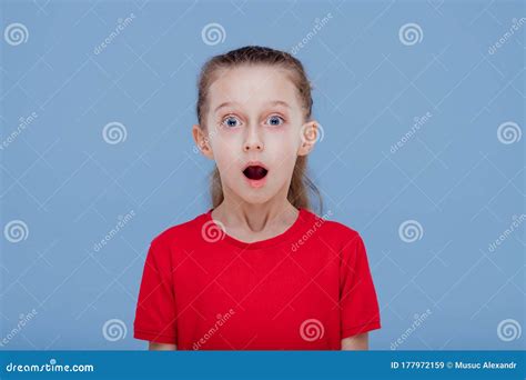 Funny Shocked Little Girl With Mouth Opened In Casual Red Outfit Stock