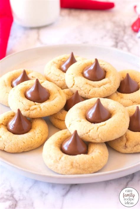 Cream together butter, both sugars and peanut butter. Thumbprint Hershey Kiss Cookies for Christmas - Easy ...