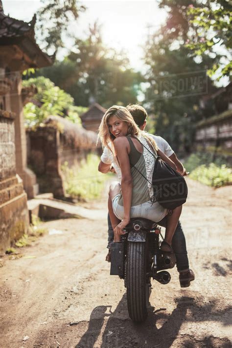 Rear View Shot Of Young Couple Riding Motorcycle On Rural Road Beautiful Young Female Sitting