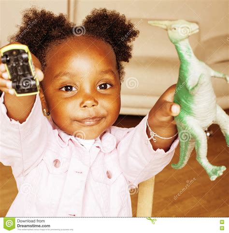 Litle Cute Sweet African American Girl Playing Happy With Toys At Home