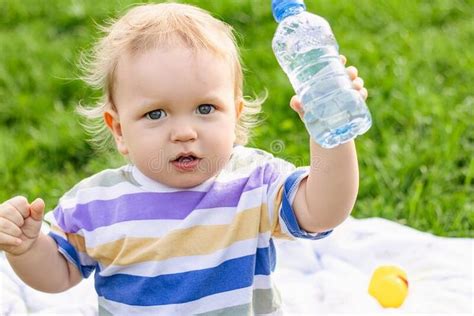 Cute Little Boy Drinking Water From Bottle Royalty Free Stock Photo