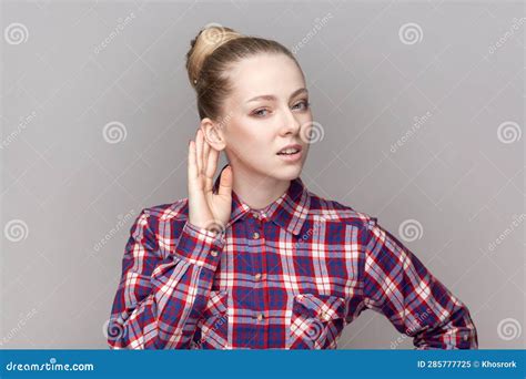Curious Woman With Bun Hairstyle Keeping Hand Near Ear And Listening To