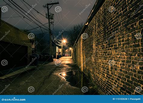 Vintage Brick Wall In A Dark Gritty And Wet Chicago Alley Stock Photo