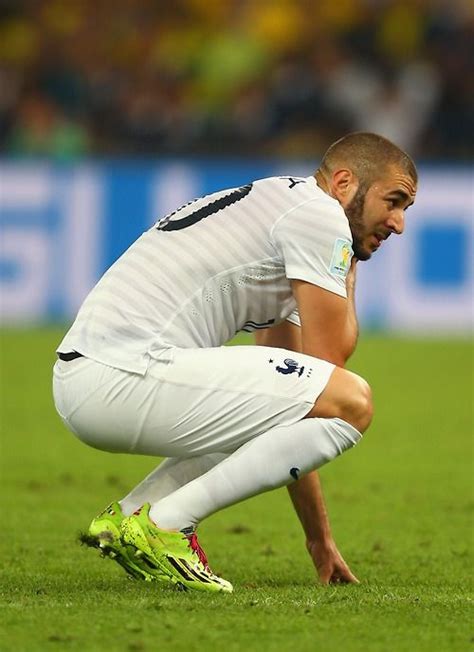 a man kneeling down on top of a soccer field