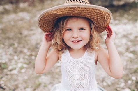 Premium Photo Happy Little Girl Wearing A Hat Outdoors