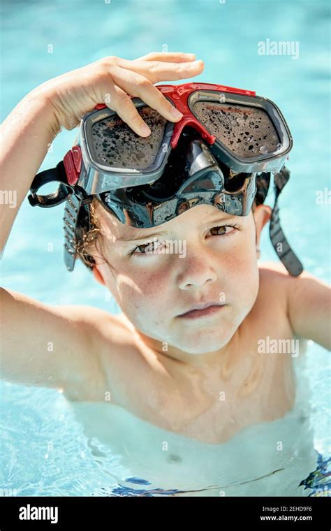 Adorable Little Boy In Snorkeling Goggles Swimming In Outdoor Pool
