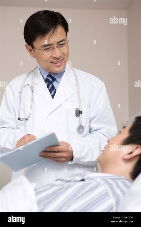 Doctor Examining A Patient Stock Photo Alamy