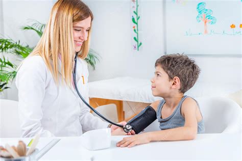 Premium Photo Pediatrician Measuring Boys Blood Pressure