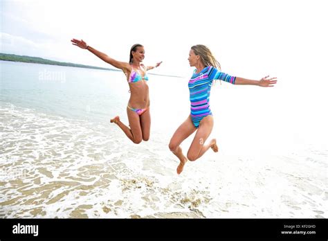 Two Women Having Fun On The Beach Stock Photo Alamy