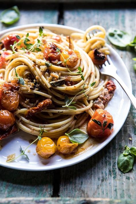 A White Plate Topped With Pasta And Vegetables On Top Of A Wooden Table