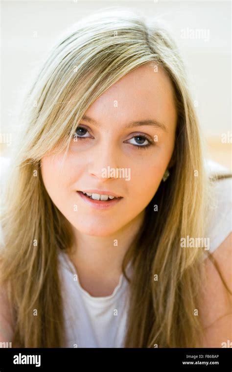 head and shoulder shot of teenage 16 18 years old woman facing eyes looking up long blonde