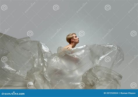 Lonely Half Naked Woman Sit Suffering From Nature Pollution With Plastic Bags Around Stock