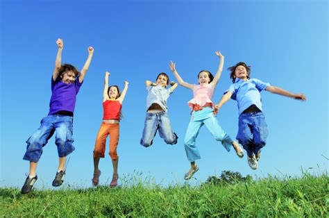 Group Of Five Happy Children Jumping Outdoors Sinai And Synapses