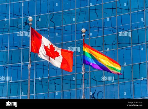 Canadian Flag Next To Rainbow Flag In Toronto Canada Stock Photo Alamy