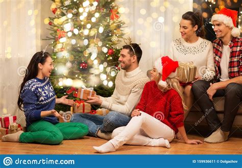 Friends Celebrating Christmas And Giving Presents Stock Image Image