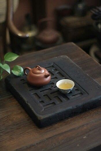 A Beautiful Still Life Of A Chinese Tea Pot And Cup With Freshly Brewed