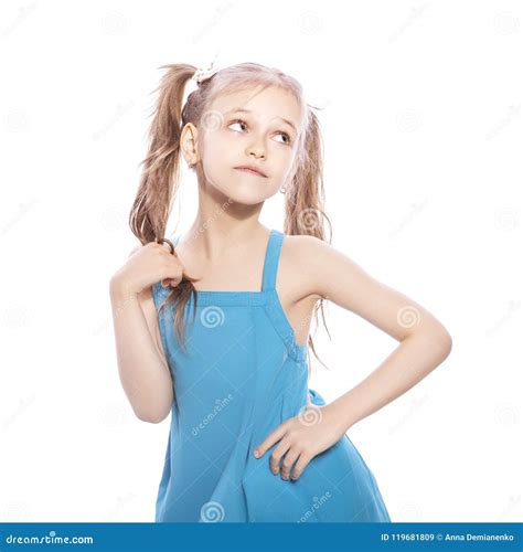 Young Seven Years Old Brunette Girl In Blue Dress On A White Iso Stock