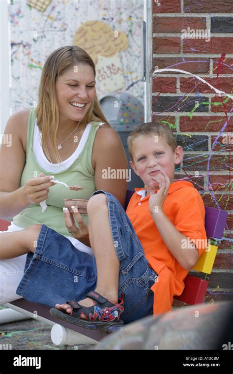 Boy Who Is Caught Fed By Her Mom And Embarrassed Stock Photo Alamy