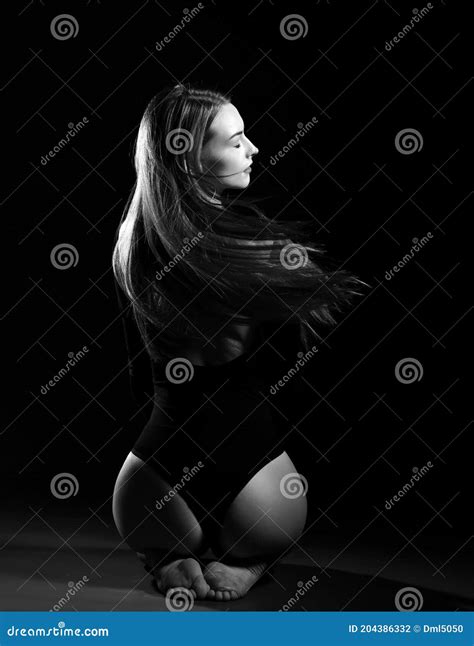 Young Beautiful Woman With Long Silky Straight Hair In Dark Body