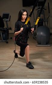 Brunette Girl Electrical Muscular Stimulation Suit 스톡 사진 659238574