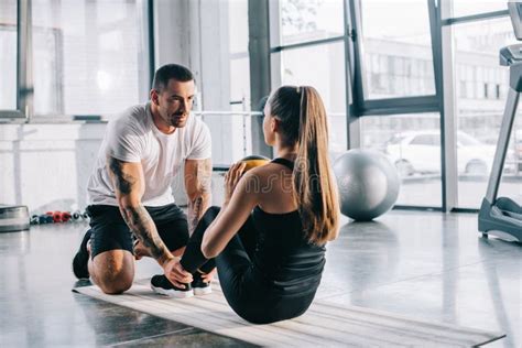 Male Personal Trainer Helping Sportswoman Stock Photo Image Of
