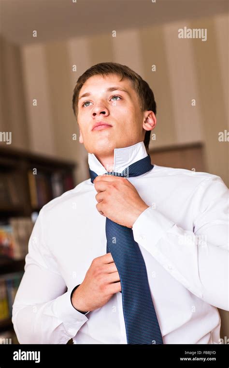 Portrait Of A Man Adjusting His Shirt And Tie Stock Photo Alamy