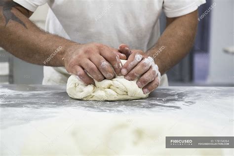 Cropped View Of Hands Of Baker Kneading Bread Dough — Work Wear Baking
