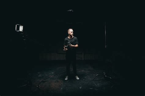 Man Standing In The Middle Of A Dark Room · Free Stock Photo