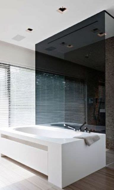 A Large White Bath Tub Sitting Inside Of A Bathroom Next To A Window
