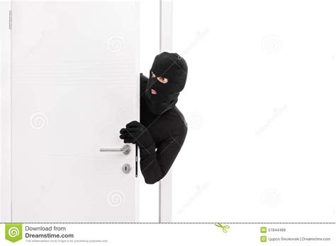 Thief Breaking Into A Room And Carefully Looking Around