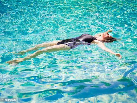 Woman Lying On Clear Water At Tropical Beach Beautiful Mature Girl