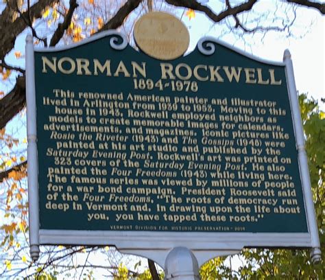 The Information Sign For Norman Rockwell In Front Of A Tree With Leaves