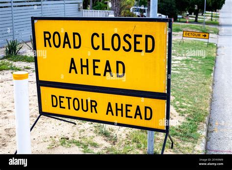 Yellow Traffic Detour Sign Showing Road Closed Ahead Stock Photo Alamy