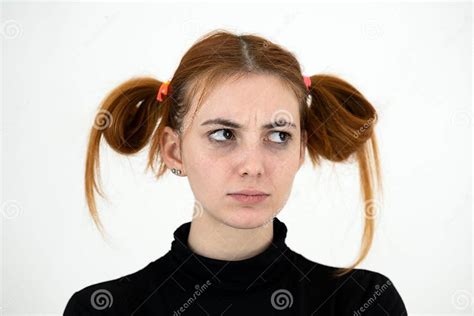 Closeup Portrait Of A Sad Redhead Teenage Girl With Childish Hairstyle