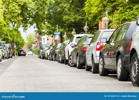 Rows Of Cars Parked On The Roadside In Residential District Stock Photo