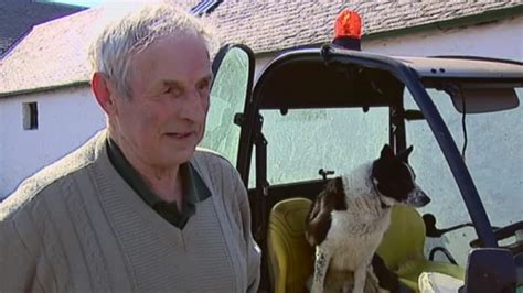 Farmer Tom Hamilton And His Sheepdog Don Sitting In A Tractor