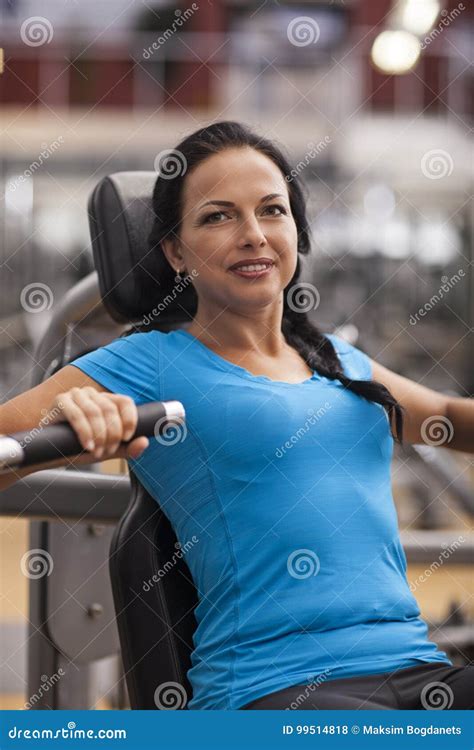 Bodybuilding Woman Exercising In Gym With Exercise Machine Arms Back