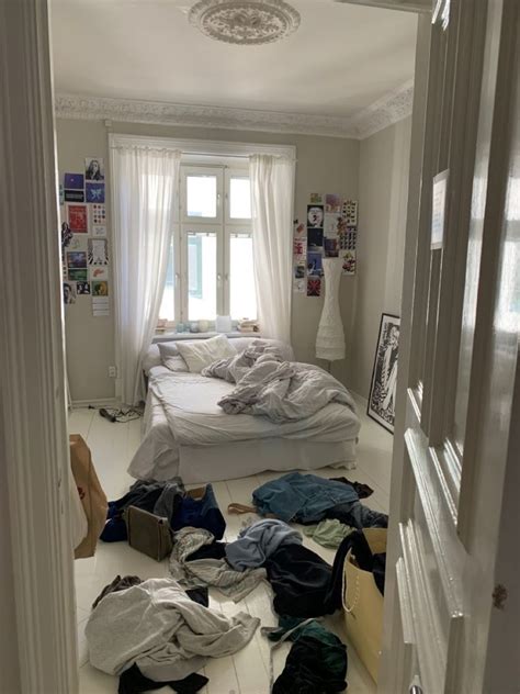 A Messy Bedroom With Clothes All Over The Floor