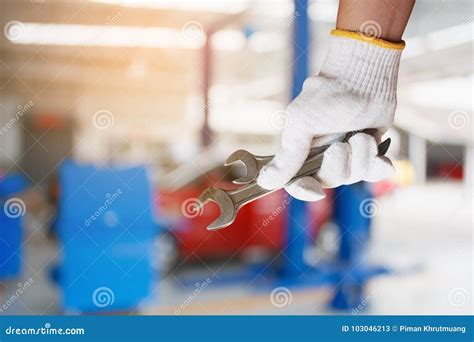 Car Mechanic Holding Wrench At The Car Repair Garage Stock Image