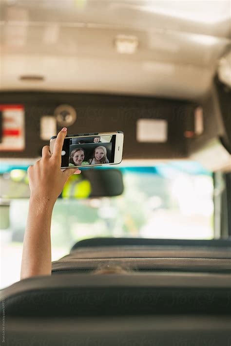 School Bus Girl Holds Up Phone To Take Selfie By Sean Locke