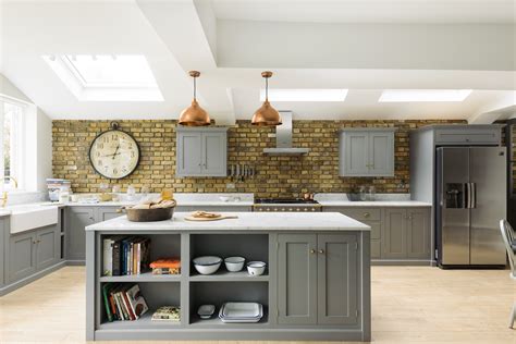 The large island in pale brown wood includes a variety of cupboards and drawers in the body for extra storage. A perfect Kitchen Island - The deVOL Journal - deVOL Kitchens