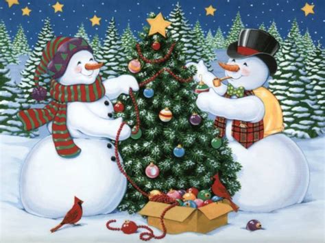 Snowmen Decorating A Christmas Tree Pictures Photos And Images For