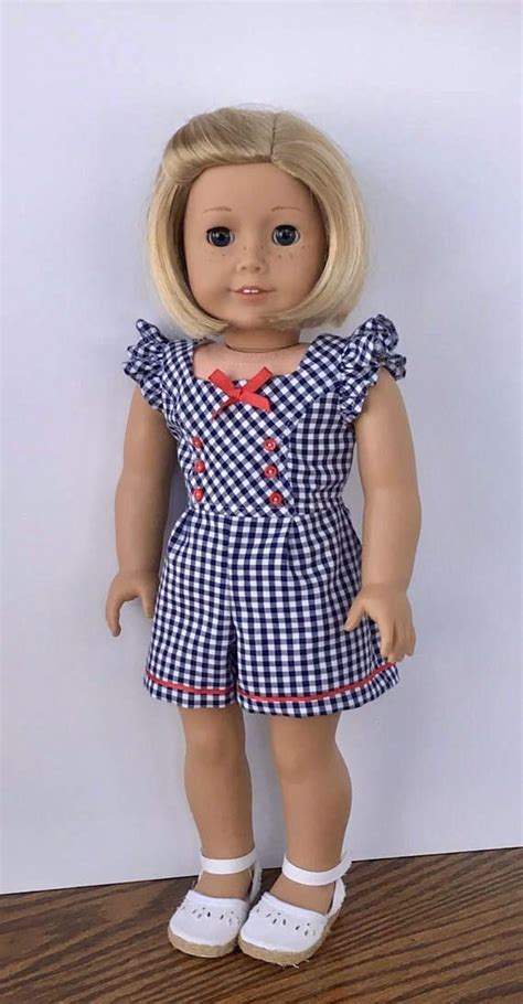 A Doll With Blonde Hair Wearing A Blue And White Checkered Dress On A