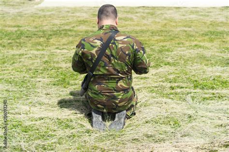 Soldier On His Knees Praying And Surrendering Prisoner Asks For Mercy