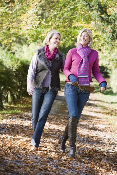 Mother And Grown Up Daughter On Walk Through Woods Stock Photo Image