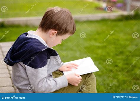 7 Year Old Boy Reading A Book On The Terrace Stock Image Image Of