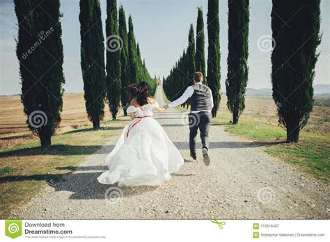 happy stylish smiling couple walking and kissing in tuscany ita stock image image of bride