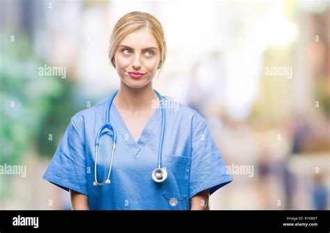 Young Beautiful Blonde Doctor Surgeon Nurse Woman Over Isolated