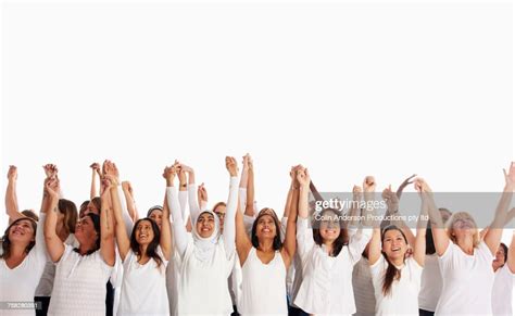 Crowd Of Diverse Women Holding Hands With Arms Raised High Res Stock