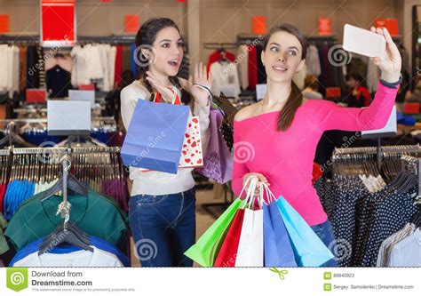 two beautiful girls makes selfie in a shopping centre stock image image of enjoying payment
